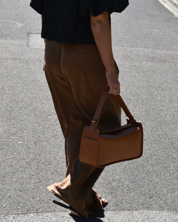 RHEA-Pram-Bag-Saddle-Tan-as-handbag