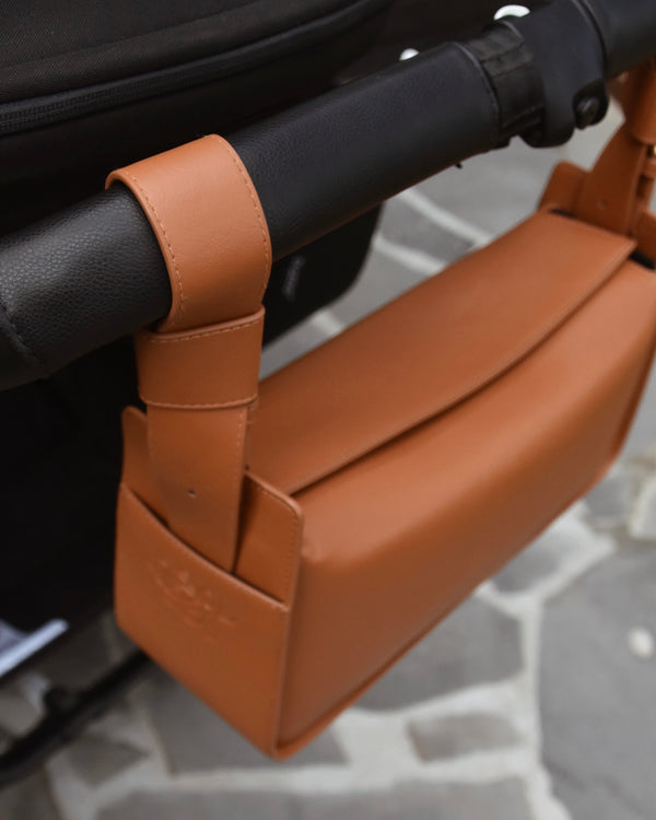 RHEA-Pram-Bag-Saddle-Tan-on-pram-handlebars